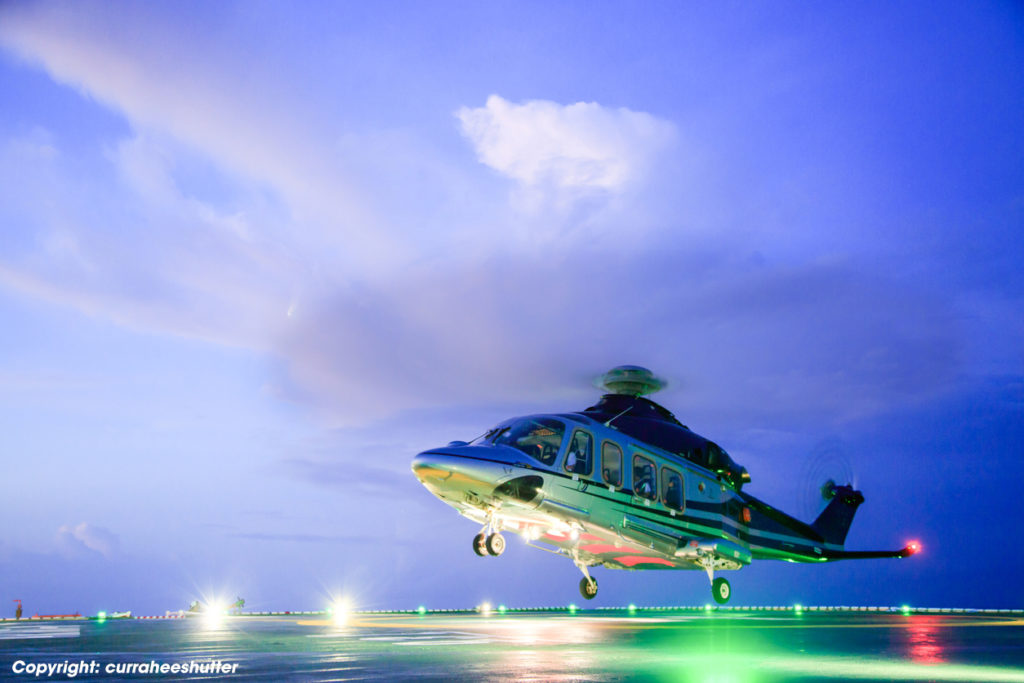 helicopter parking landing on offshore platform. Helicopter transfer crews or passenger to work in offshore oil and gas industry.Night flight training of Pilot and coordinate pilot.